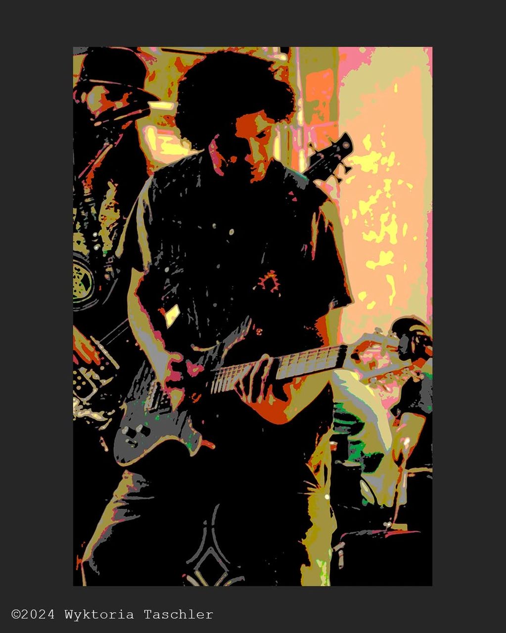 Curly haired man looks down to play his electric guitar. He is accompanied by the bassists and drumm