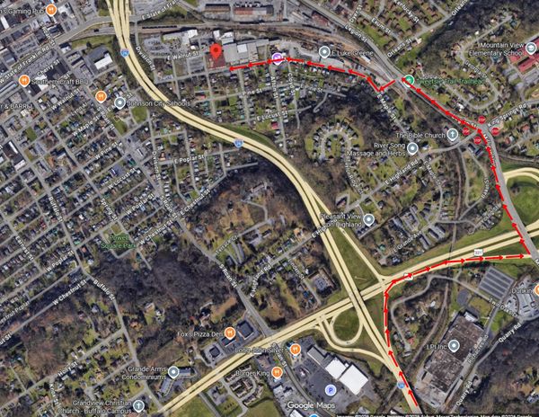 A satellite map showing a red route through a suburban area with highways and local streets.