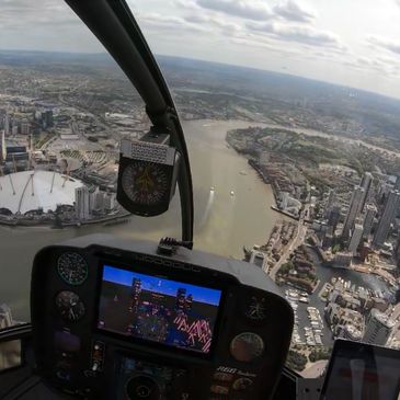 Flying in a helicopter over London the o2 and the river Thames 