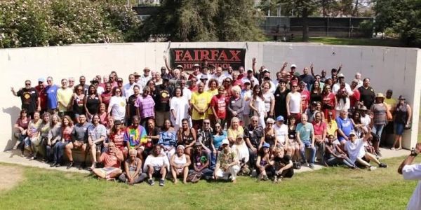 Large group photo outdoors in front of a Fairfax High School banner.