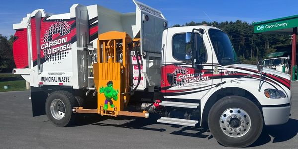 Garbage truck with Carson Disposal logo and Hulk graphic.