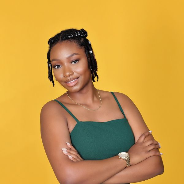 A serene landscape with a sunset over a lake, reflecting vibrant colors and silhouettes of trees.