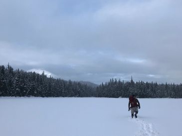 man walking through snow in Alaska 