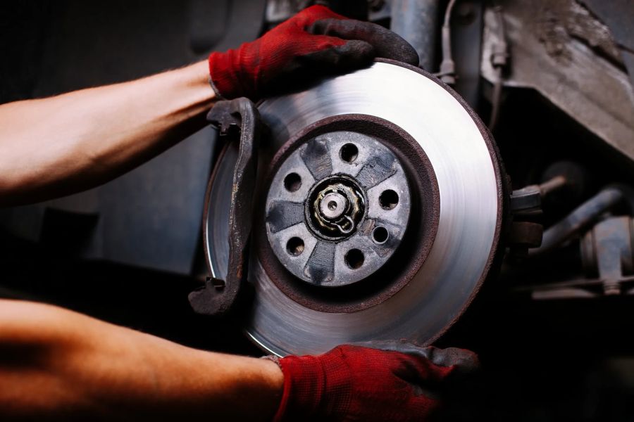 Mechanic repairing a car brake disc