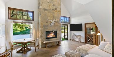 Bright living room with stone fireplace and cozy seating.