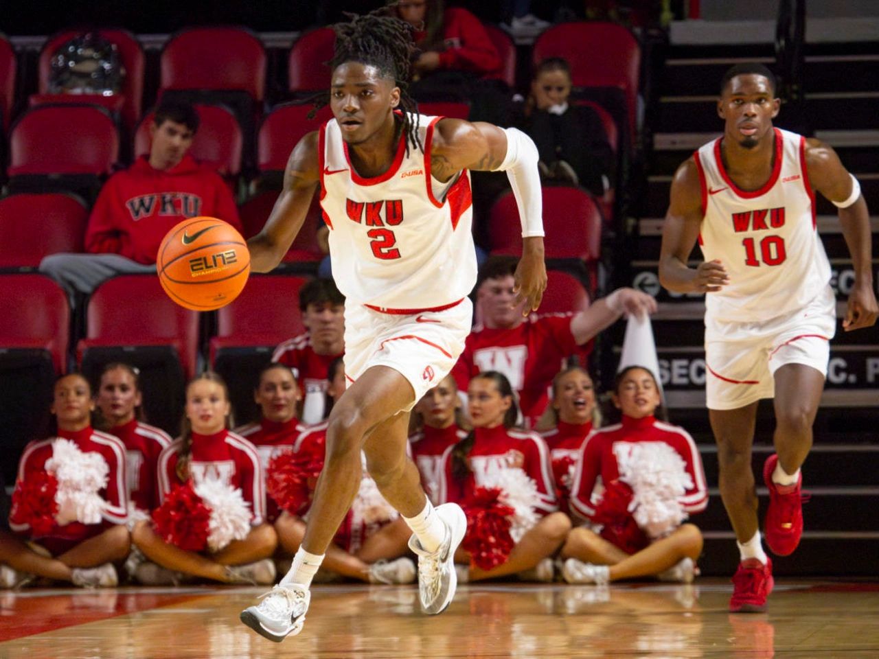 WKU basketball players Don McHenry (left) and Brandon Newman (right) dribble the ball down to their 