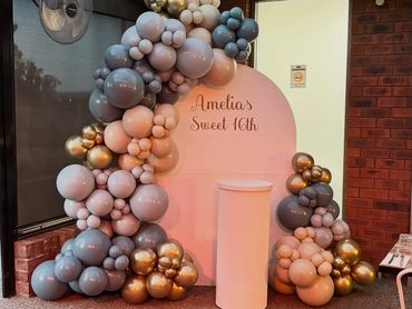 Elegant balloon arch and backdrop for Amelia's Sweet 16 celebration.