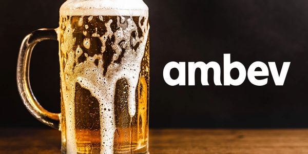 A frosty mug of beer with foam dripping, next to the Ambev logo.