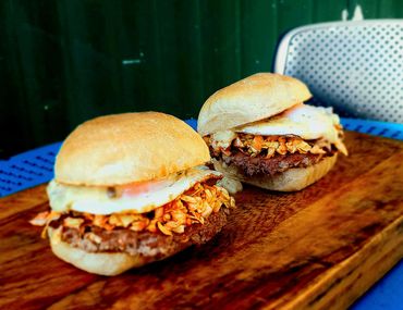 Burger of the week special featuring Bacon Patty, fried organic egg and kimchi.