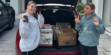 Volunteers helping transport books to Achieve Miami classrooms 