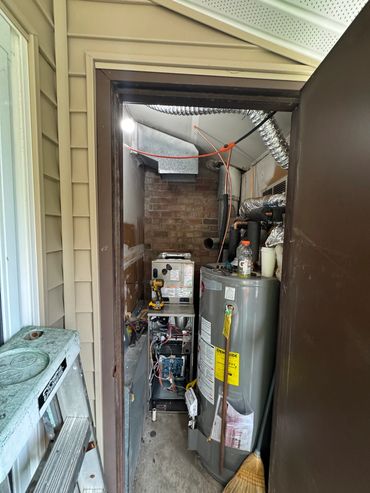 Closet with water heater and furnace.