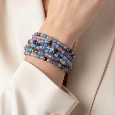 Colorful beaded bracelet wrapped around wrist.