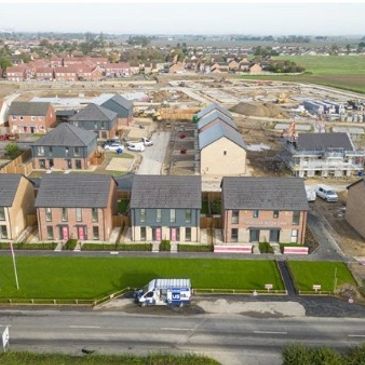 A suburban housing development with new houses and construction in progress.