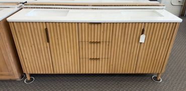 Wooden sideboard with three drawers and metal legs on carpeted floor.
