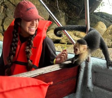 Visitante disfrutando de un encuentro cercano con un mono durante el recorrido en  por Monkey Island