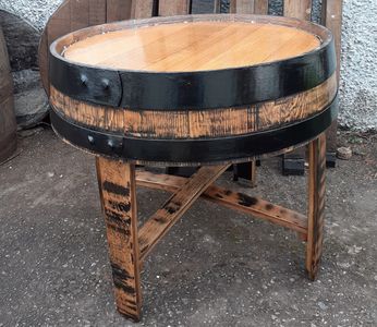 a table made from the top section of a hogshead whisky barrel made by wee dram barrel creations