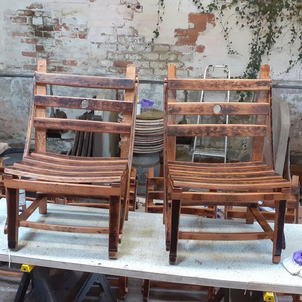 a pair of whisky barrel  stave dining chairs on the workbench