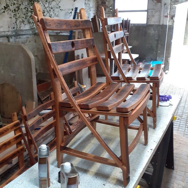 a pair of whisky barrel  stave dining chairs on the workbench