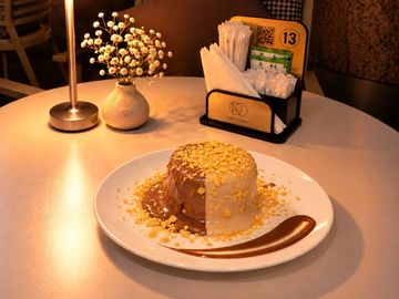 A dessert topped with oats on a white plate.