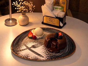Molten chocolate cake with ice cream and berries.