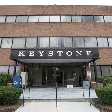 Entrance to a brick building with a sign that reads 'KEYSTONE'.