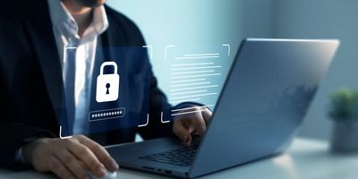 A man is using his laptop to lock up the password.