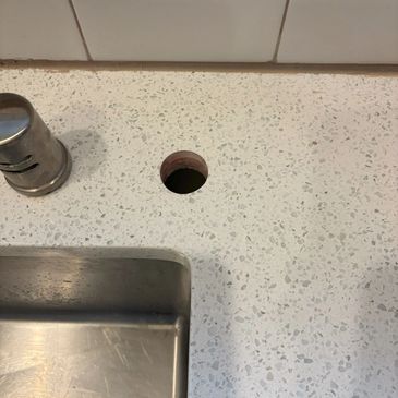 Precision core drilling in a quartz countertop for a retrofit air switch installation,  clean