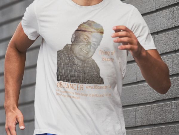 A person wearing a white t-shirt with a cancer awareness design and a smiling man's photo.