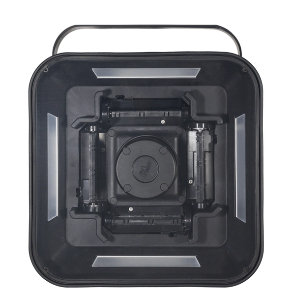 Top view of a black, square-shaped device with a central circular component.