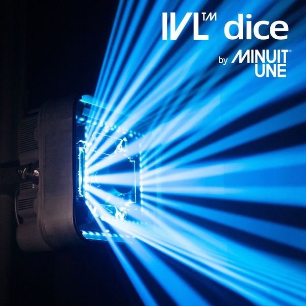 Blue light beams radiate from a stage light with IVL dice branding.