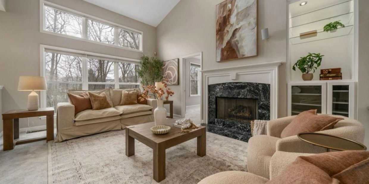Cozy living room with fireplace and large windows.