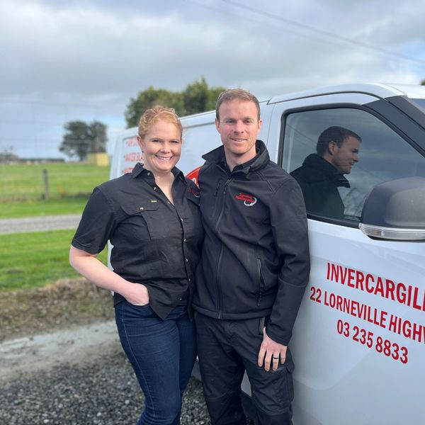 Owners, Holly and Sam smiling with van