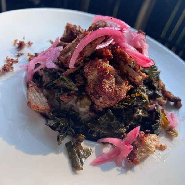 Slow roasted pulled pork carnitas, atop bacon and apple cider vinegar simmered turnip greens, quick 