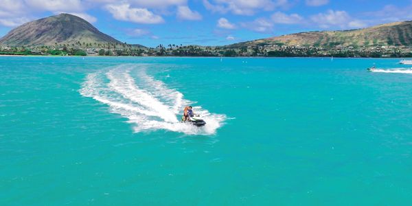 A long shot of the man skiing on the blue color sea