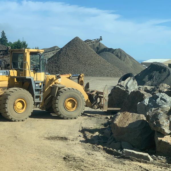 Loader at a local hard rock quarry with moving boulders 