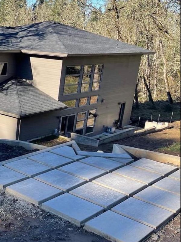 Concrete slabs arranged in a stepped pattern outside a modern house.