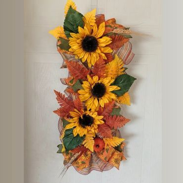 Autumn sunflower floral arrangement with fall leaves and wheat.