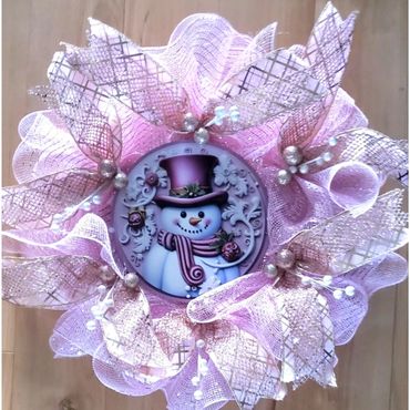 Pink Christmas wreath with snowman center.