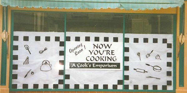 Now You're Cooking windowfront with opening soon sign. 