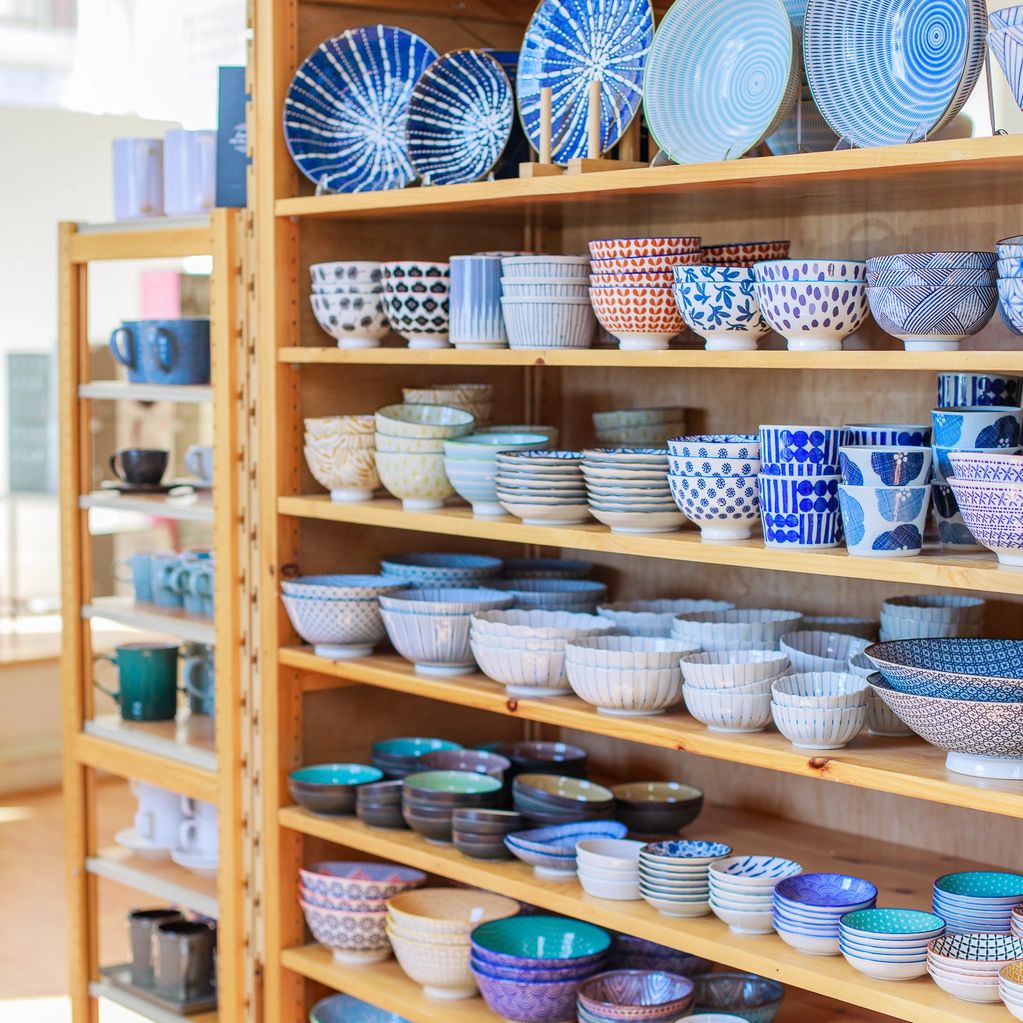 Plates and bowls on a shelf. 