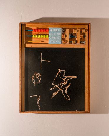 Wooden educational board with chalk drawings on blackboard.