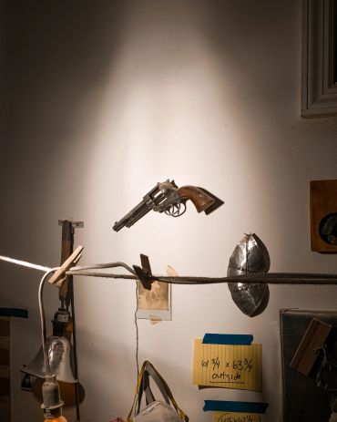 Revolver suspended in mid-air in an indoor setup.