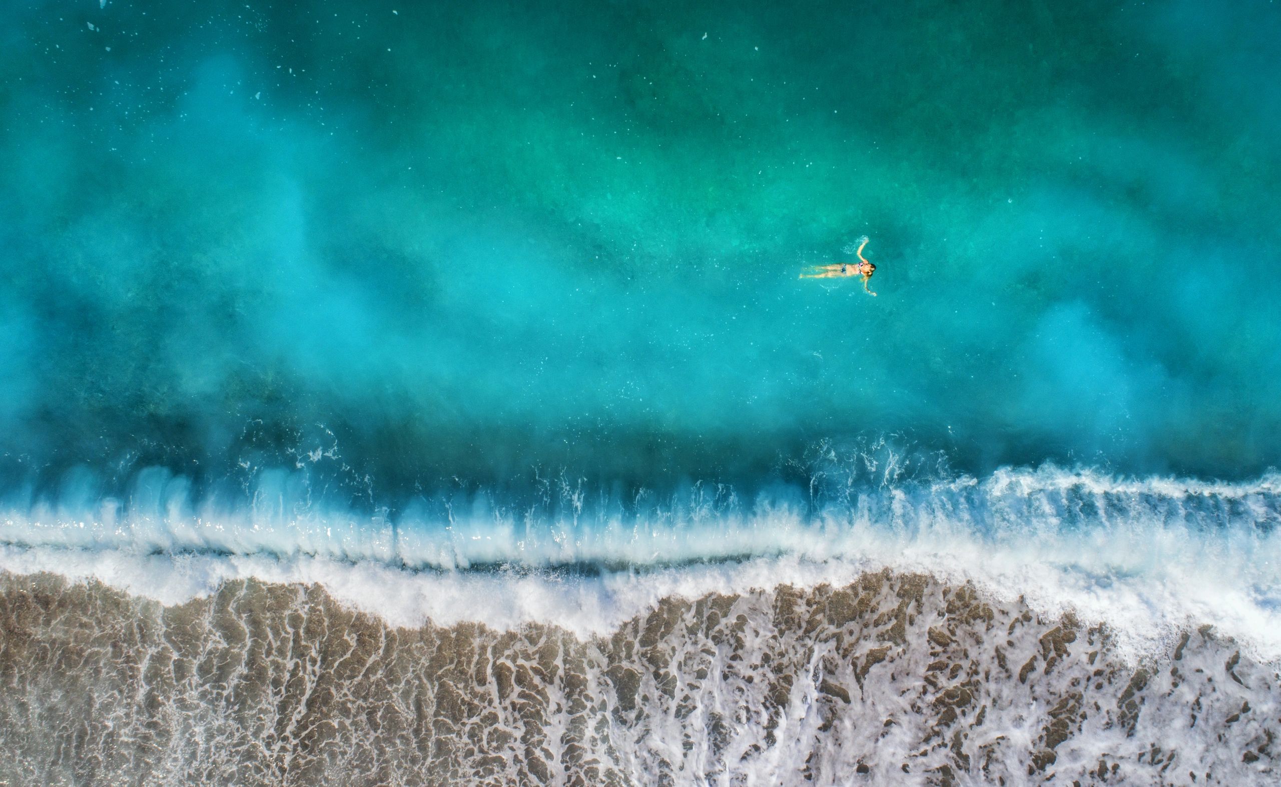 https://img1.wsimg.com/isteam/ip/6b536f48-239e-4b28-bf85-f4459a4f4d1e/aerial-view-of-swimming-woman-in-mediterranean.jpg