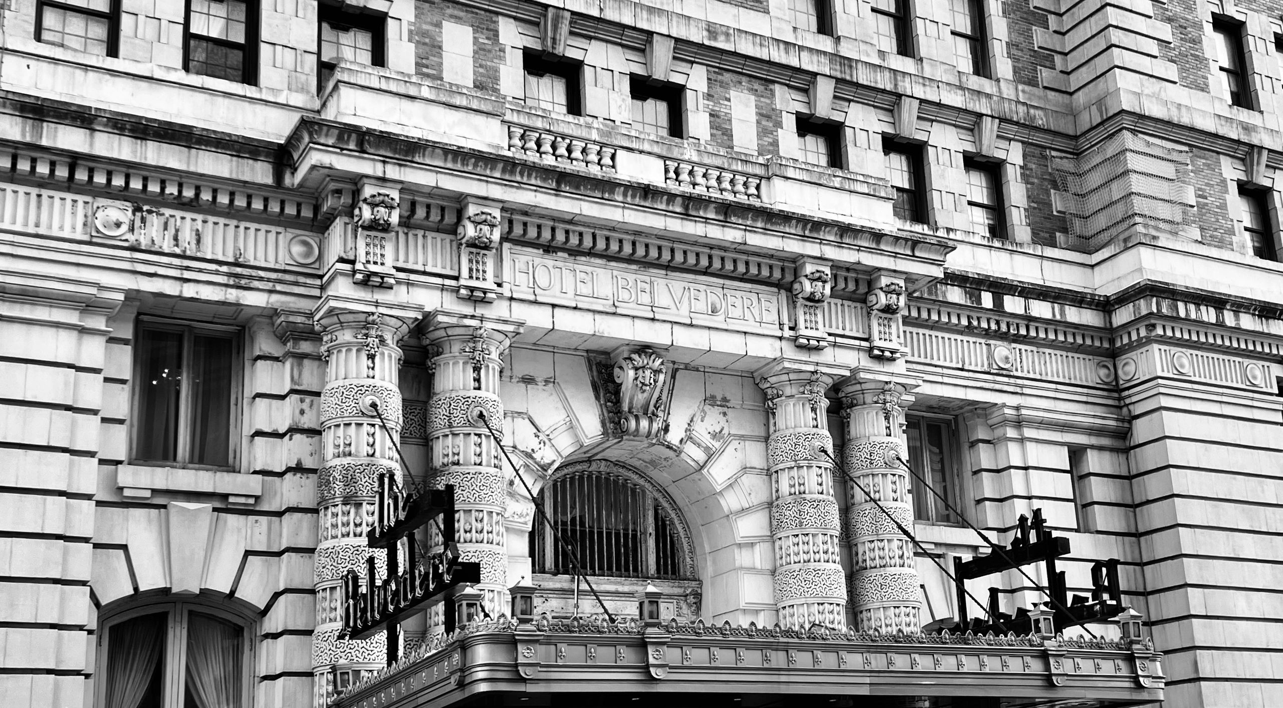 Ornate entrance of Hotel Belvedere with intricate stone columns.