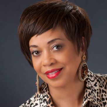 Woman with short hair smiling.