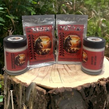 Indigenous-themed coffee and chocolate products displayed on a tree stump outdoors.