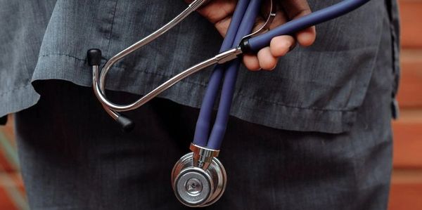Person holding a purple stethoscope.