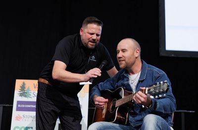 Patrick McDonald singing with an attendee while presenting at the Vancouver Island Safety Conference