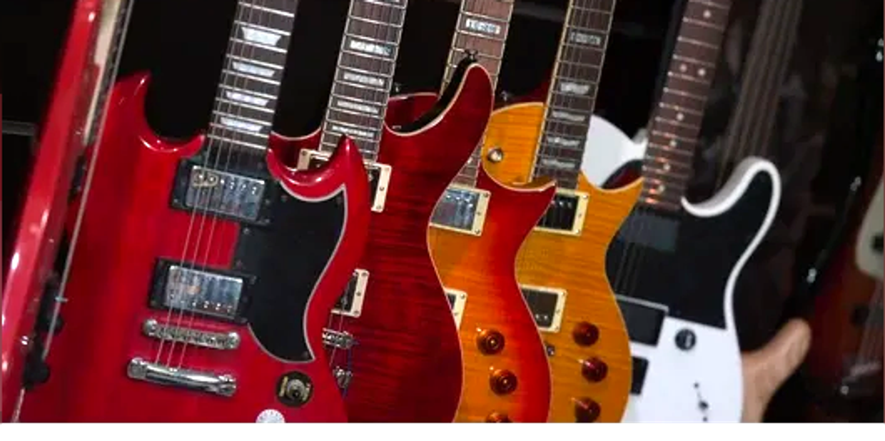 Lineup of colorful electric guitars.