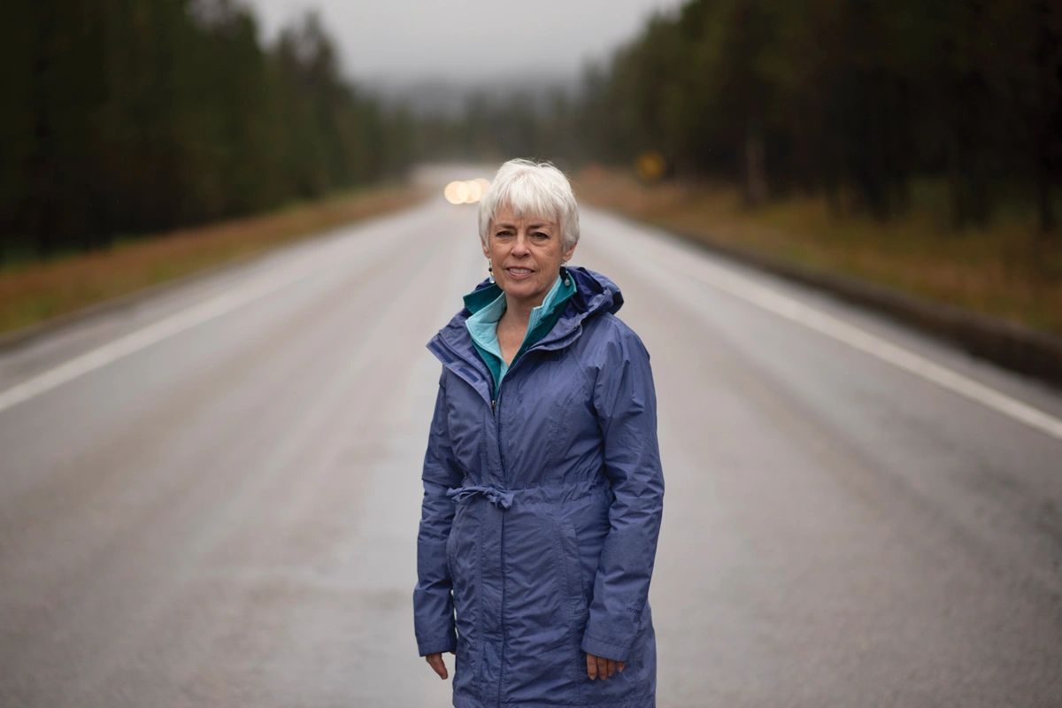 Jean Bjerke on U.S. 20 near the summit of Targhee Pass on the Idaho/Montana border. Bjerke has been a vocal proponent of wildlife passage structures for the area, where numerous wildlife-vehicle collisions have occurred.    Photo by Bradly J. Boner for High Country News